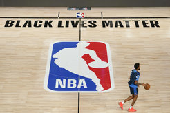Oklahoma City Thunder's Terrance Ferguson (23) takes the court for practice in an NBA basketball arena Friday, Aug. 28, 2020, in Lake Buena Vista, Fla. The writing "Black Lives Matter" can be seen at the courtside, written as an expression of solidarity with the antiracist demonstrations.