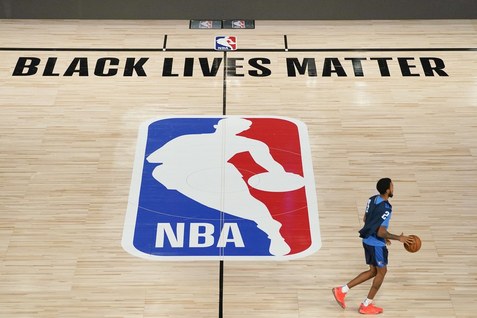 Oklahoma City Thunder's Terrance Ferguson (23) takes the court for practice in an NBA basketball arena Friday, Aug. 28, 2020, in Lake Buena Vista, Fla. The writing "Black Lives Matter" can be seen at the courtside, written as an expression of solidarity with the antiracist demonstrations.